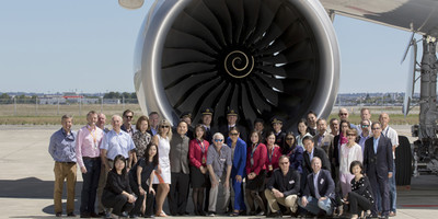 Cathay Pacific Airways' team standing in front of an Airbus A350 XWB aircraft turbine.