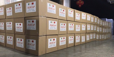 Piles of AerCap-branded boxes filled with Personal Protective Equipment.