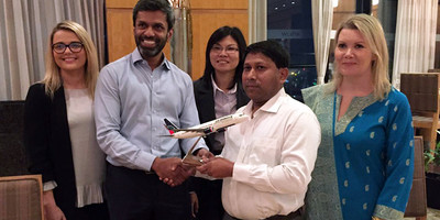 US-Bangla team posing for a photo opp with a model 737-800s aircraft.