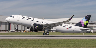Volaris' Airbus A320neo aircraft flying over a runway.