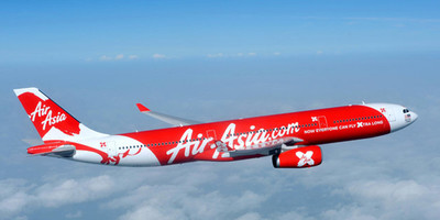 Air Asia X's A330-300s aircraft flying above the clouds.