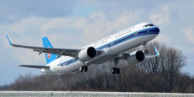 China Southern Airlines' A321neo aircraft flying over a runway.